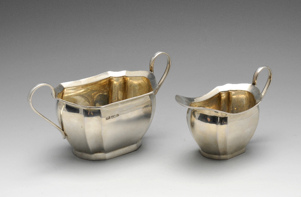 A 1940's silver milk jug and twin-handled sugar bowl, of Art Deco style and bulging form with fluted