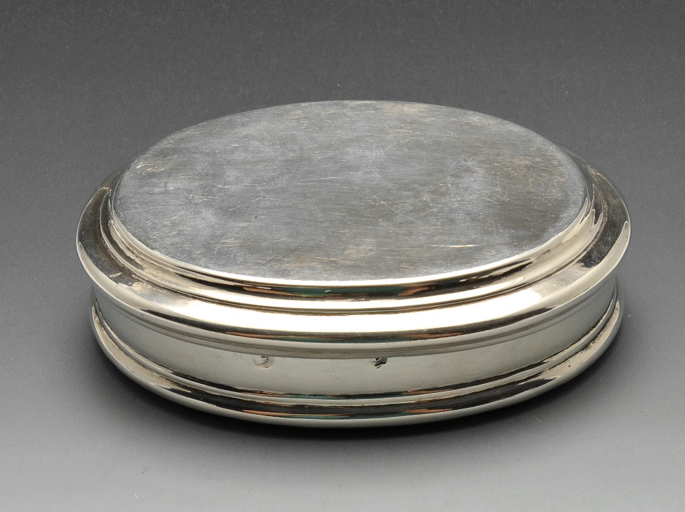 A Queen Anne silver table snuff box, the plain oval form with stepped border. Hallmarked London 1705