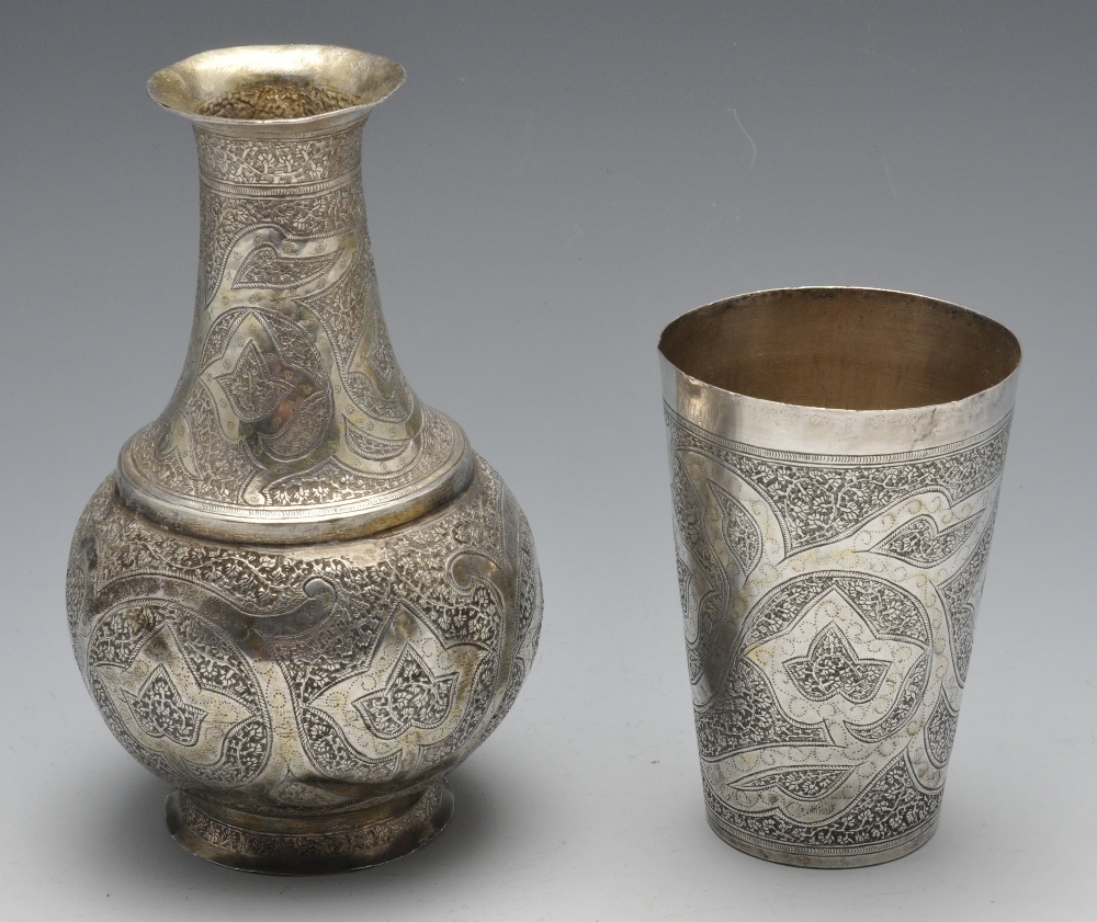 A Persian jug of vase form and ornately close chased with foliate decoration and matching tapered - Image 2 of 4
