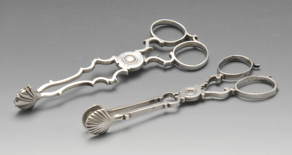 Two similar pairs of Georgian silver scissor sugar tongs, each with scroll arms with shell bowls and