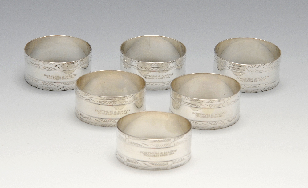 A set of six modern Fortnum & Mason silver plated napkin rings, each of circular form with