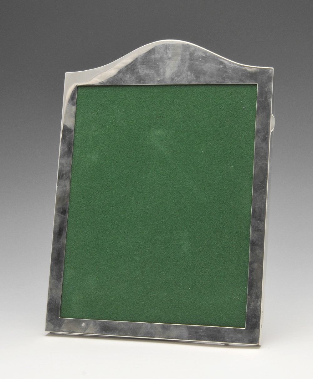 A large modern silver mounted photograph frame, of arched top form having central rectangular