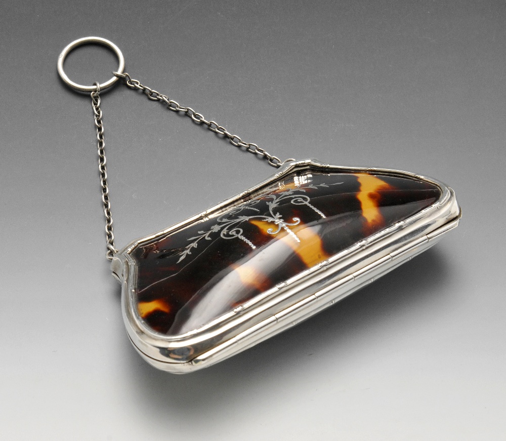 An early twentieth century silver and tortoiseshell purse, the shaped and tapered body further