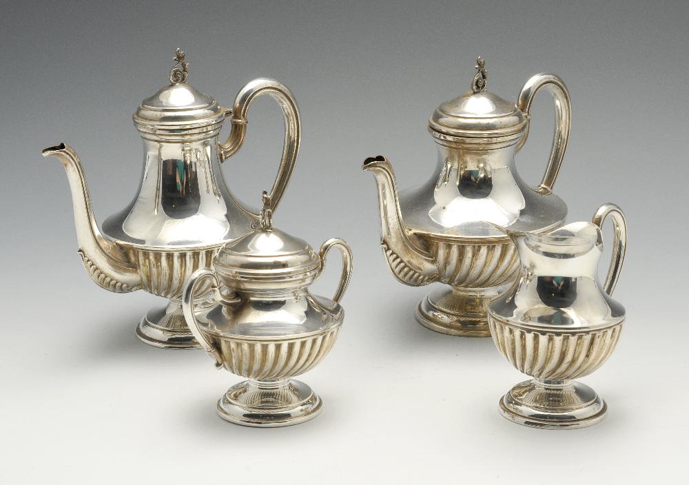 An Italian four piece silver tea service, comprising teapot, hot water pot, cream jug, and twin-