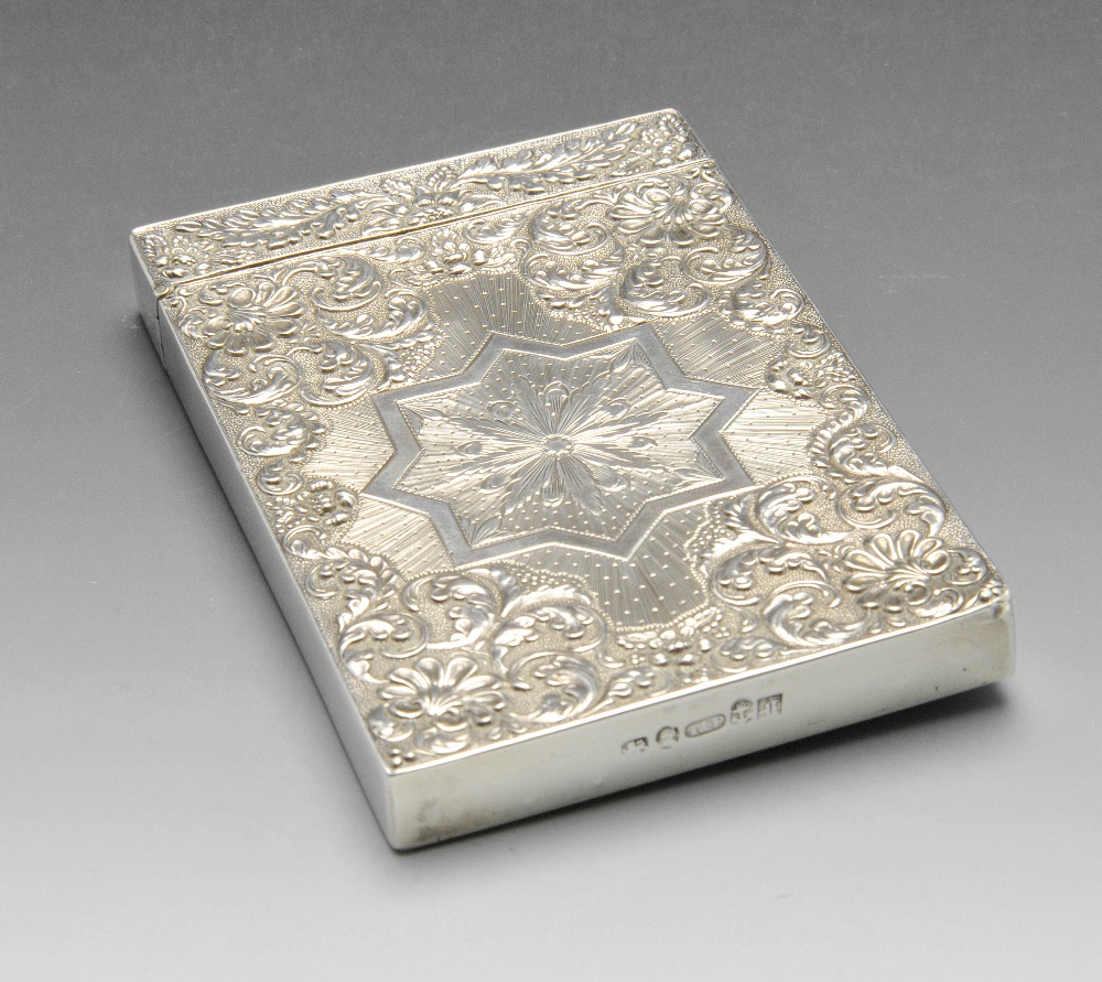 A George IV silver card case, the rectangular form ornately chased with scrolling foliage