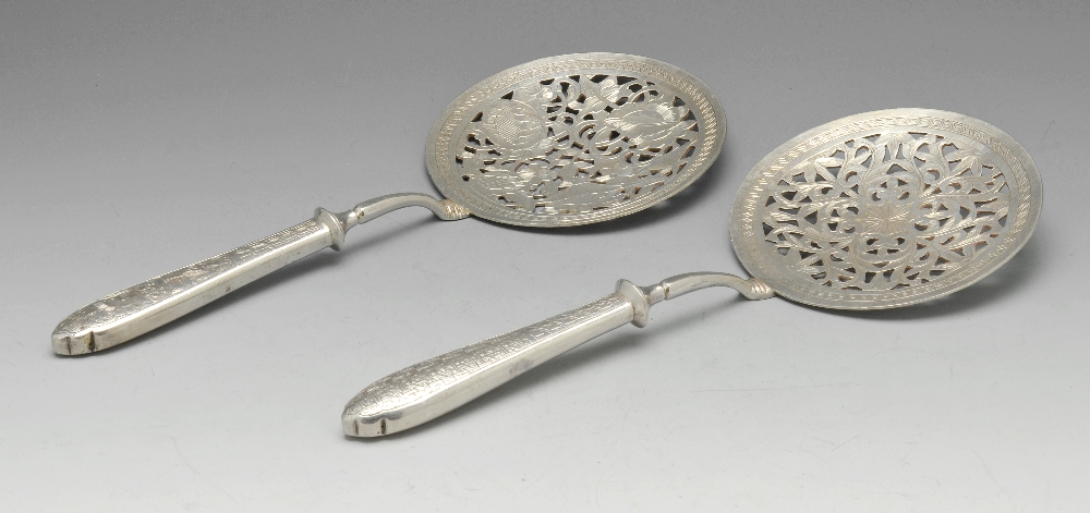 A small selection of continental flatware to include two circular servers or slices with floral