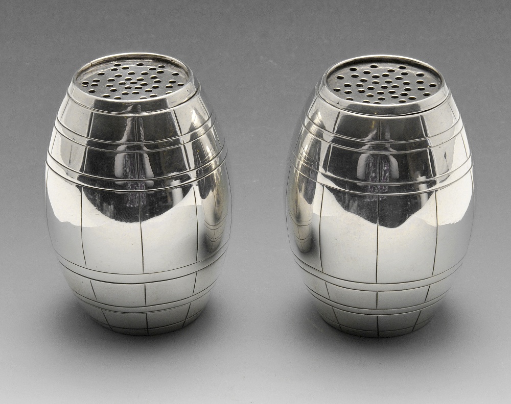 A pair of Victorian silver pepper pots of barrel form. Hallmarked Thomas Smily, London 1874.