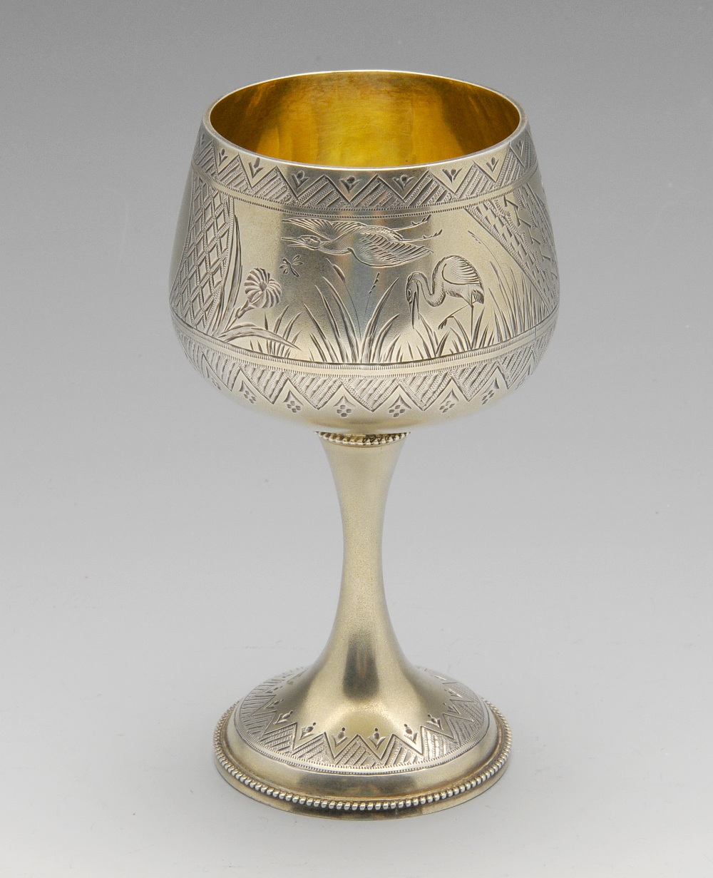 A Victorian Aesthetic Period silver-gilt goblet, the body engraved with scenes of herons amongst