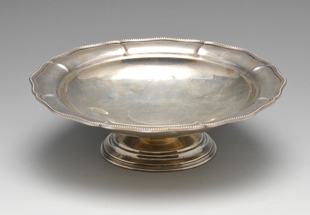 A 1930's silver bonbon dish, of lobed circular form having with beaded edge and raised upon