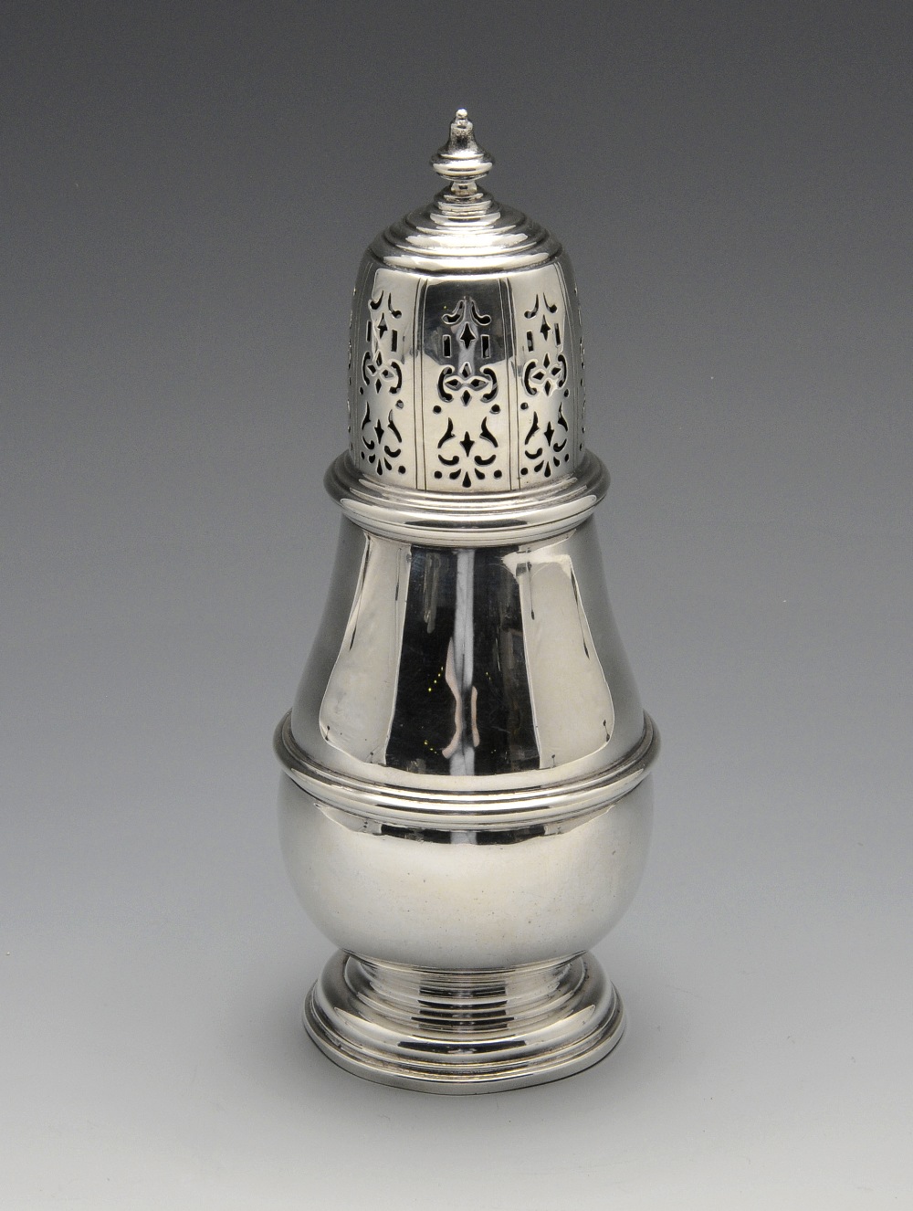 A 1930's silver caster of plain baluster form to a footed base with moulded girdle, the removable