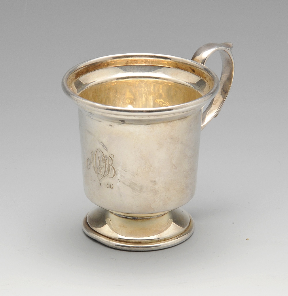 A modern silver cup, of plain form having engraved initials and date, with capped scrolling handle