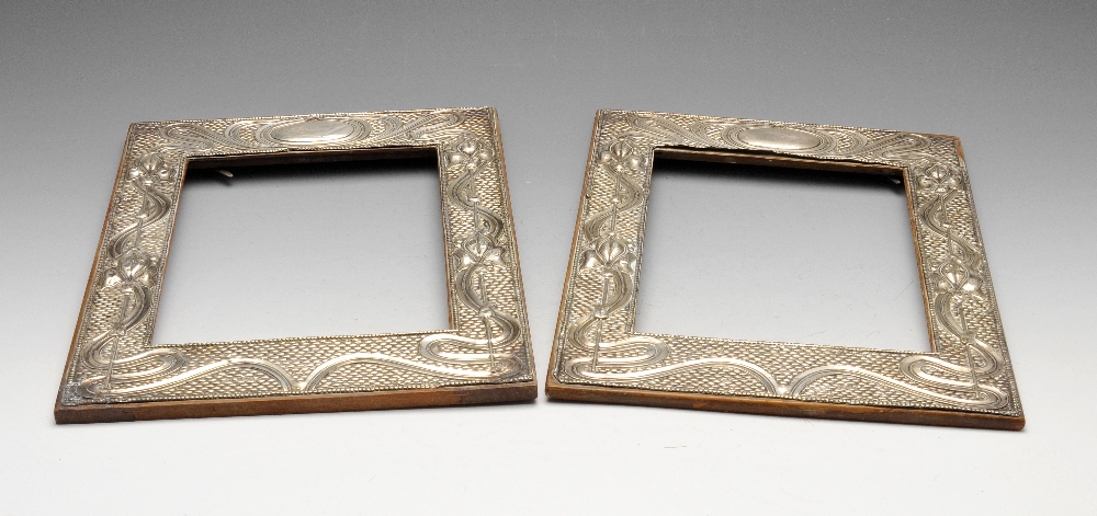 A matched pair of Art Nouveau silver mounted photograph frames, each of rectangular form and