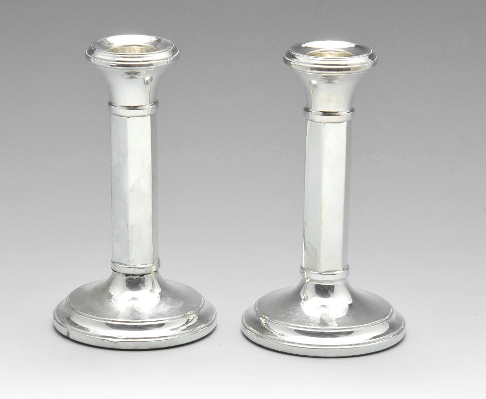 A pair of 1960's silver candlesticks, of plain form having hexagonal stems and spreading circular