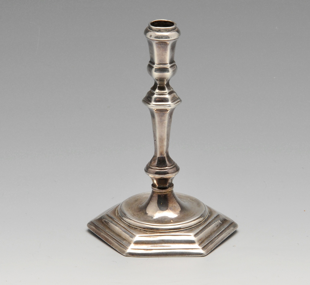 A George I Britannia silver taperstick, of faceted and knopped form leading to a hexagonal stepped