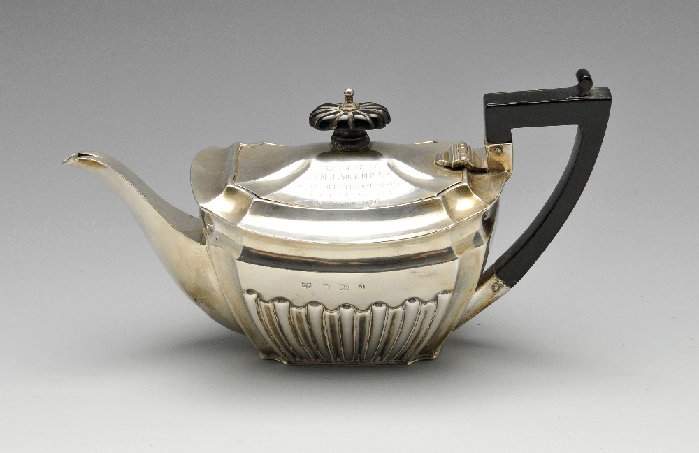 An Edwardian silver bachelor teapot, of part fluted form having presentation inscription to the