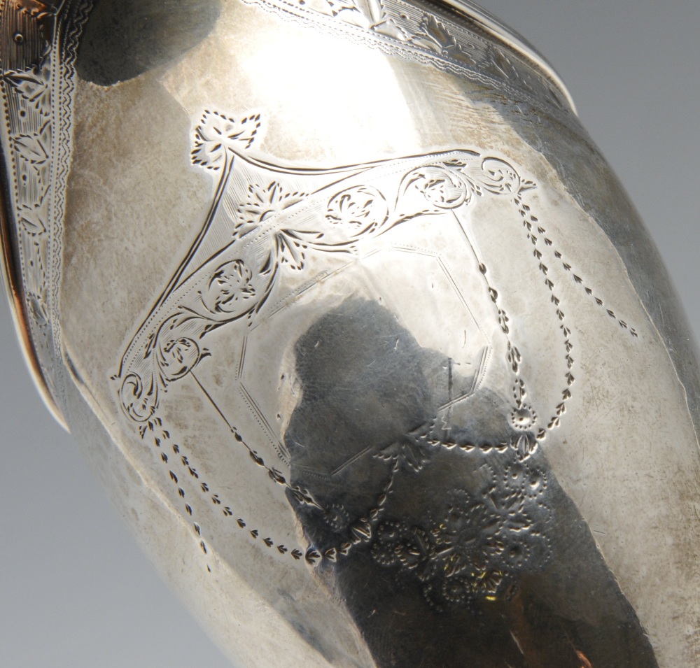 A George III silver helmet jug, the classic form with foliate border, reeded rim, garland surround - Image 3 of 5