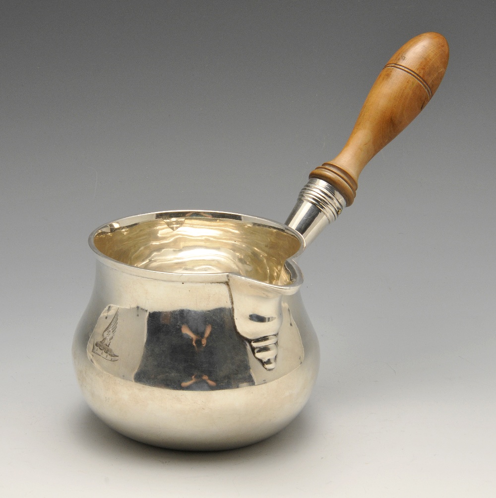 A George III large silver brandy pan, the baluster form crested and with bead-drop spout, turned