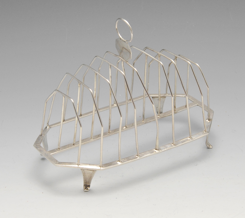 A George III silver eight-divide toast rack, the wirework tiered frame on oblong base with canted