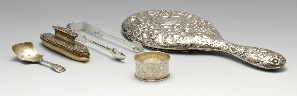 A late Victorian silver mounted hand mirror of oval form, ornately embossed throughout with