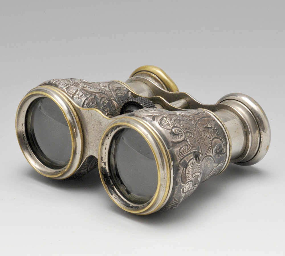 A pair of late Victorian silver mounted binoculars, the foliate barrels upon a metal body with