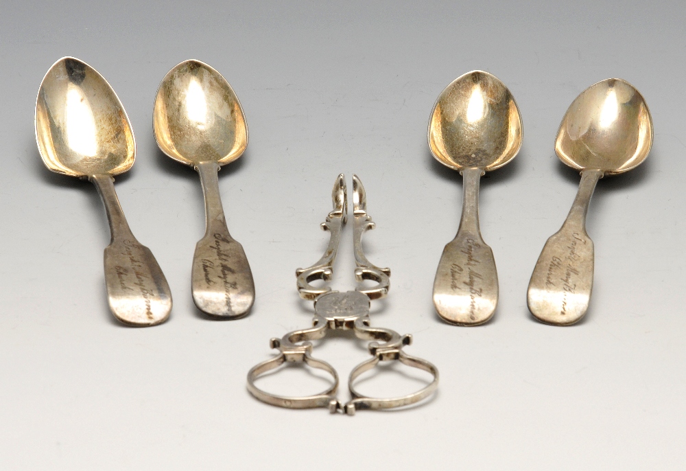 A pair of George III silver sugar tongs of scroll form, crested and with shell bowls, together