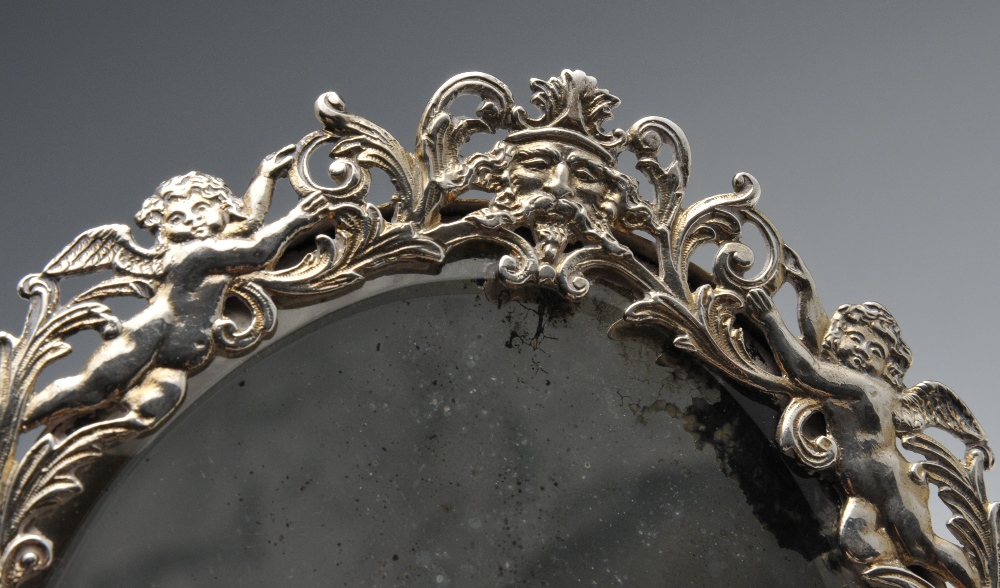 A late Victorian silver mounted hand mirror, the oval bevelled glass plate within an ornately - Image 5 of 8