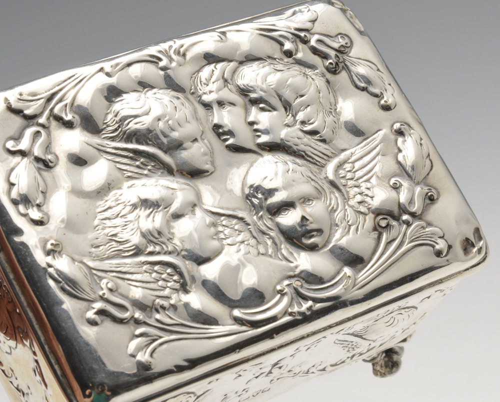 An Edwardian silver mounted jewellery box of oblong form, embossed with putti and opening to a - Image 3 of 6