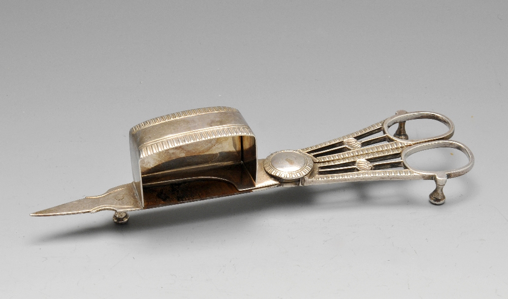 A late George III pair of silver candlesnuffers, the conventional scissor action form with gadroon