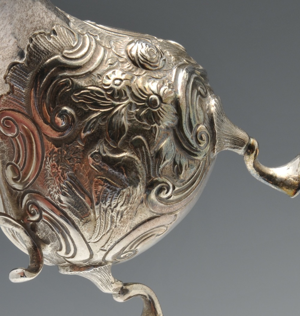 A George II silver cream jug, of globular form having waisted neck and shaped rim, decorated with - Image 4 of 9