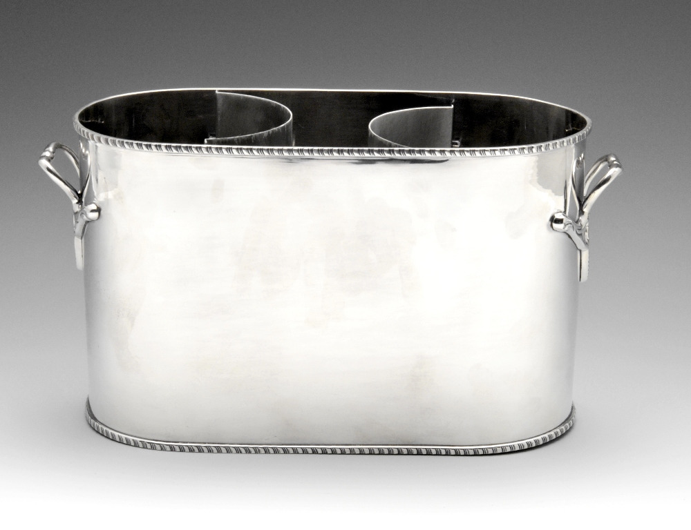 A modern silver plated dual wine cooler of oval form with stylised twin handles. Maximum height