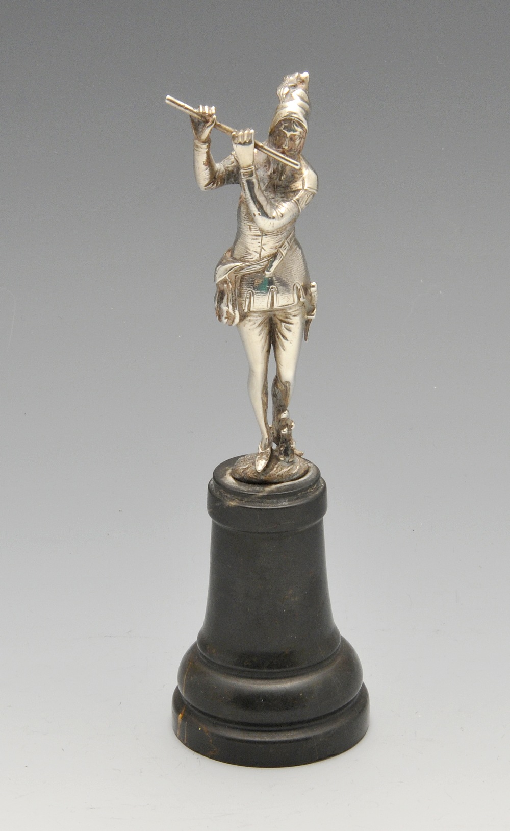 A 1920's imported silver figure realistically modelled as a man in Medieval dress playing the