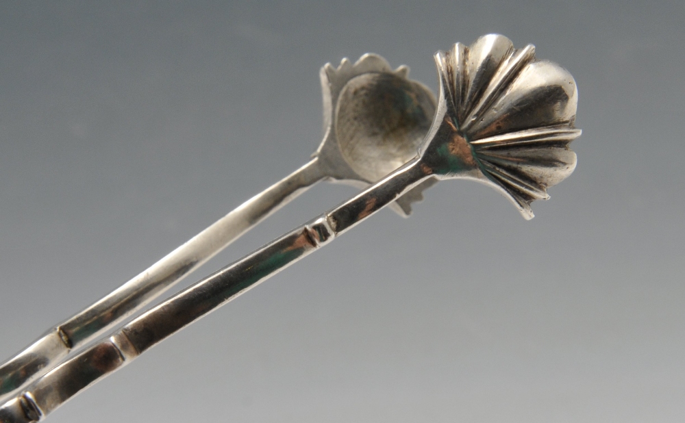 Two similar pairs of Georgian silver scissor sugar tongs, each with scroll arms with shell bowls and - Image 5 of 5