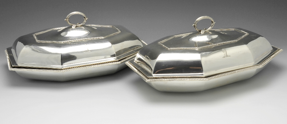 A pair of George III silver entree dish covers with later matched bases, of octagonal sided form