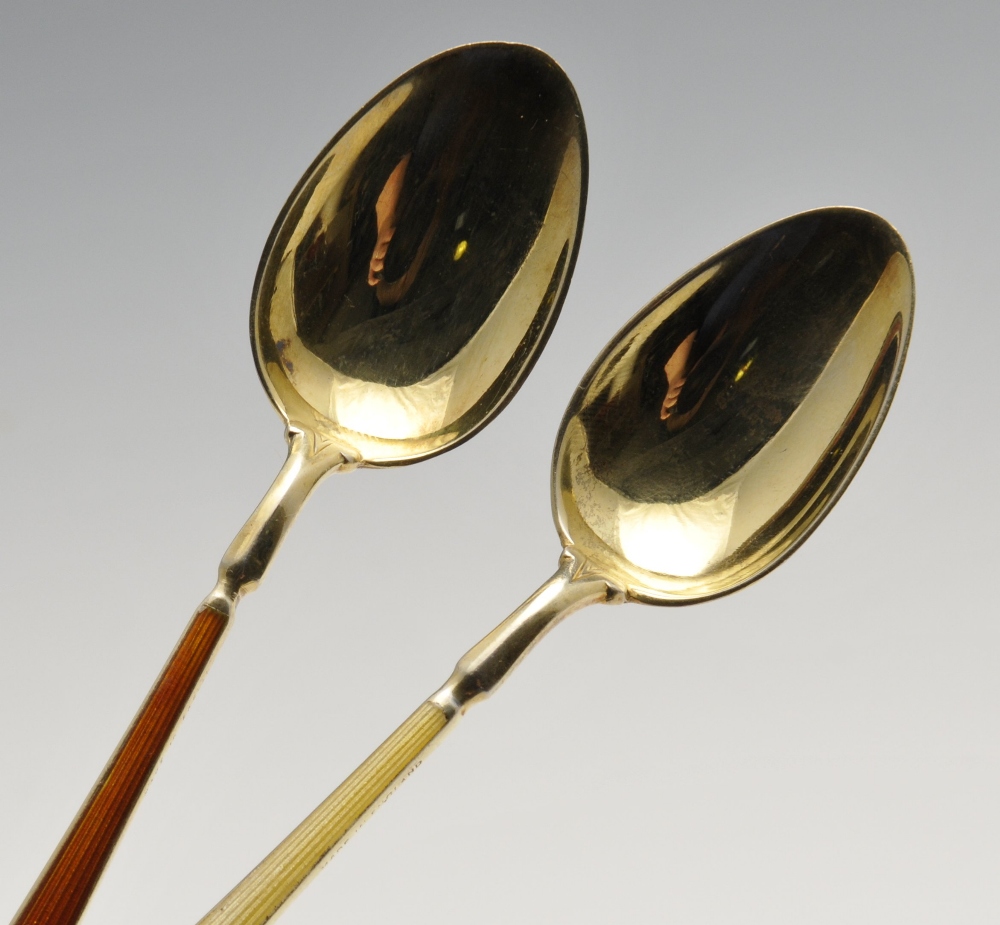 A cased set of six 1940's silver-gilt coffee spoons each having enamelled stems and bowls of varying - Image 3 of 4