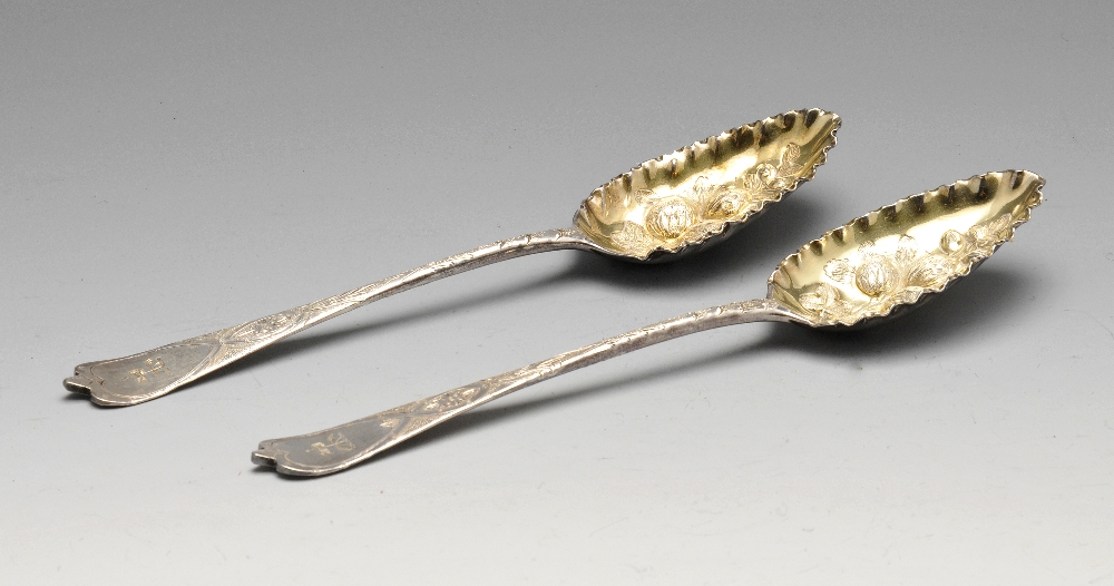 A pair of George III silver berry spoons, the silver-gilt fruiting embossed bowls with frilled