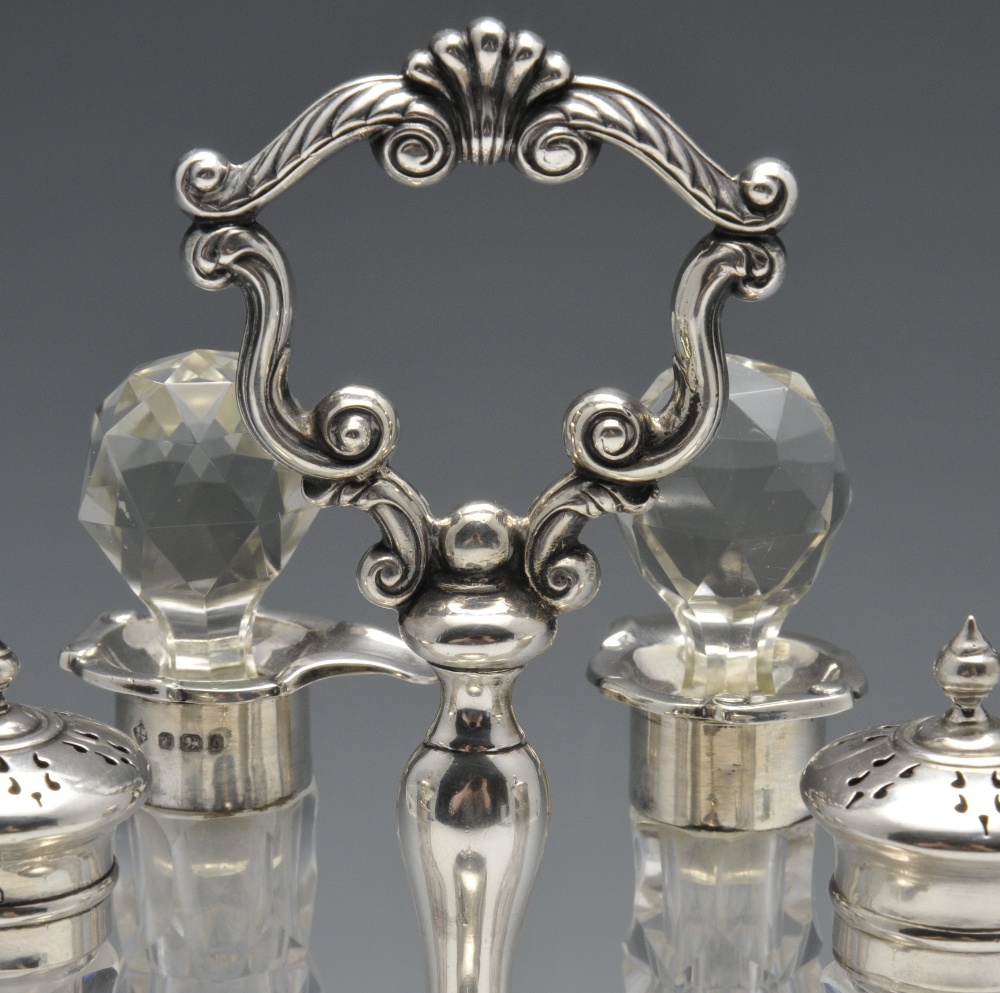 A late Victorian silver cruet stand for five bottles, having central baluster stem leading to a - Image 3 of 8
