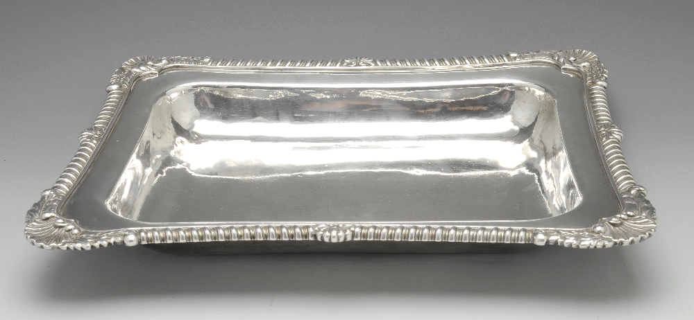 A George III silver entree dish, of shaped oblong form with applied foliate, shell and gadroon