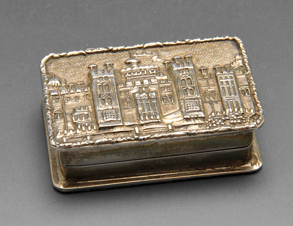 A 1970's silver castle top snuff or pill box, the hinged cover opening to reveal a gilt interior.