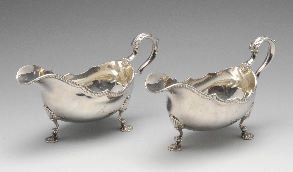 A matched pair of modern silver sauce boats, each of typical bellied form with shaped gadroon rim