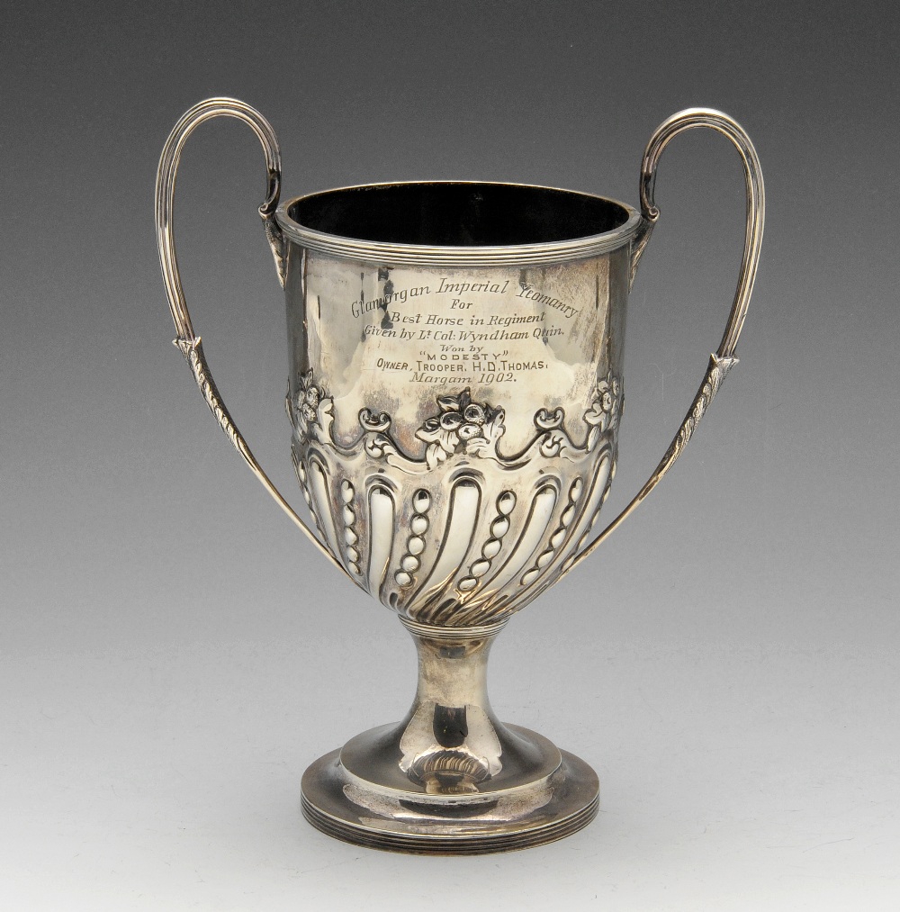 A late Victorian silver twin-handled trophy, lobed and beaded decoration to the lower body with