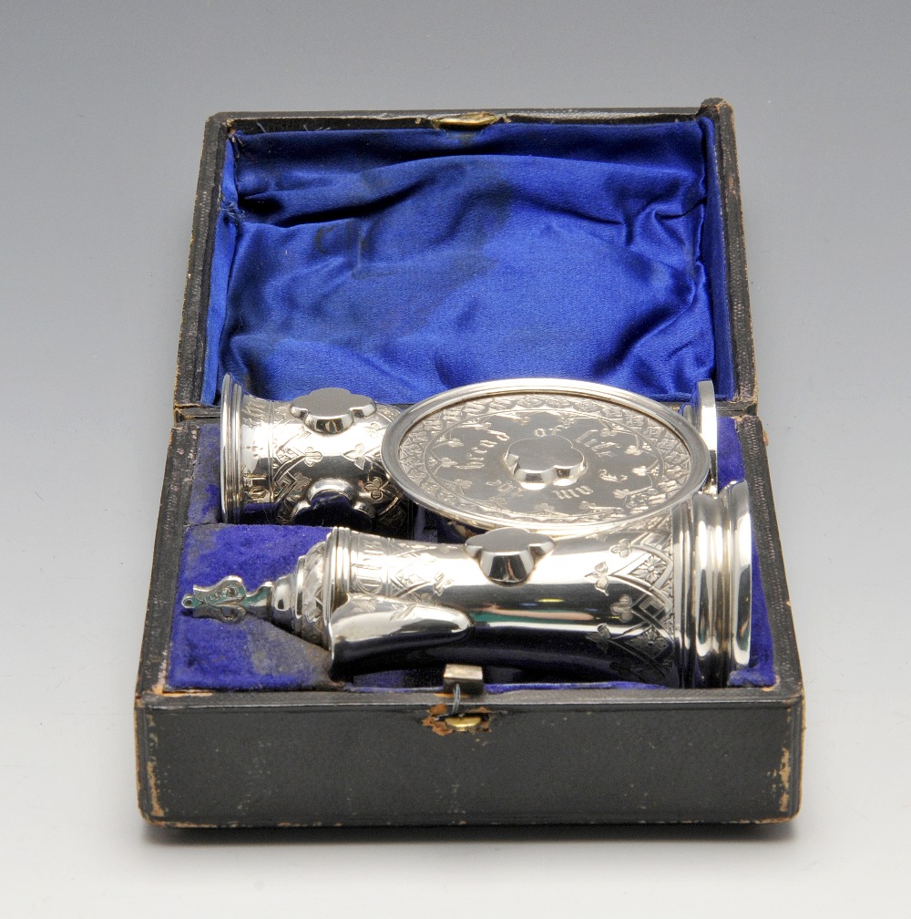 A Victorian silver cased Communion set, comprising a chalice, flagon and paten, each decorated