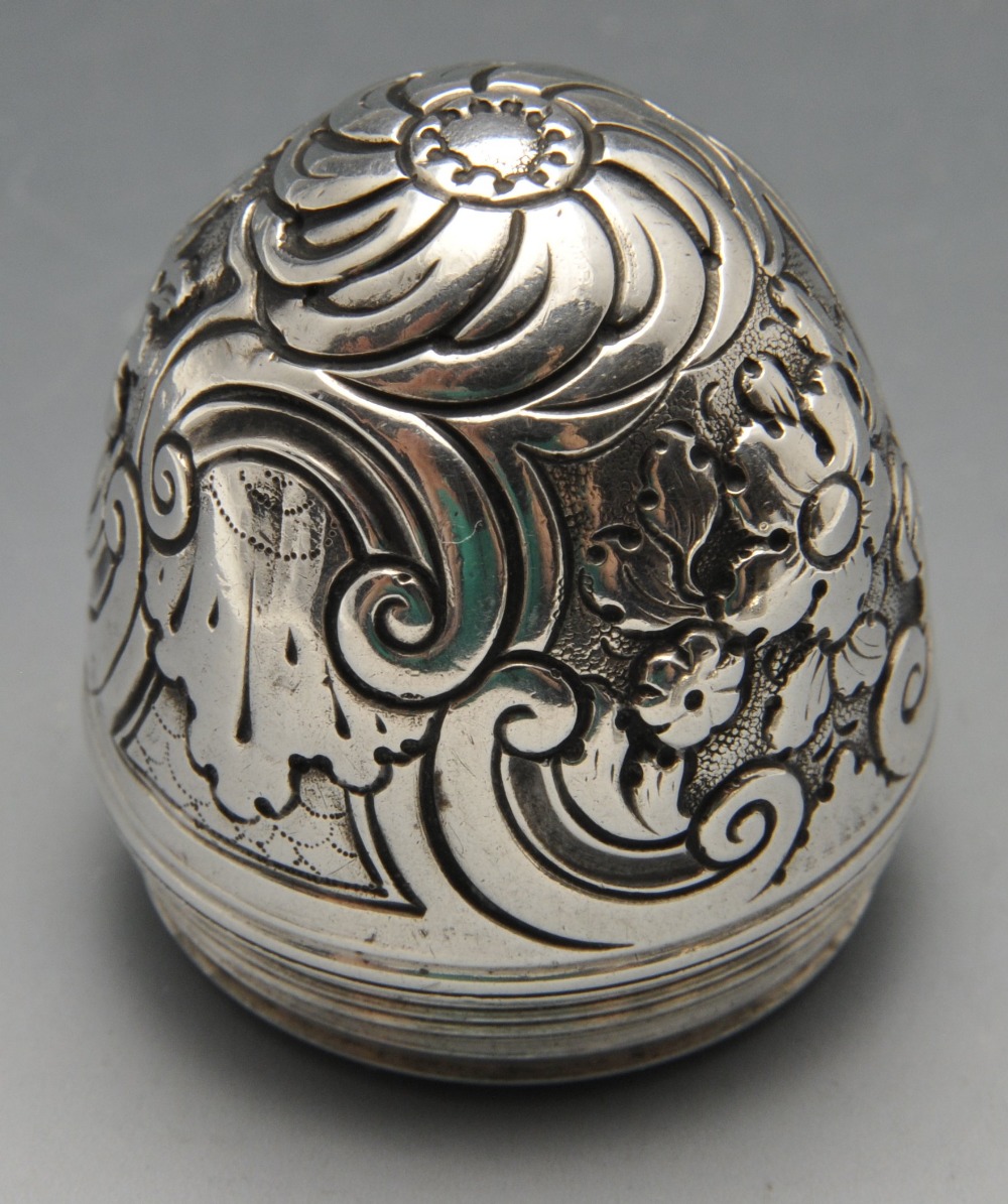 An eighteenth century nutmeg grater, the ovoid form with floral and scroll embossed decoration. - Image 4 of 4