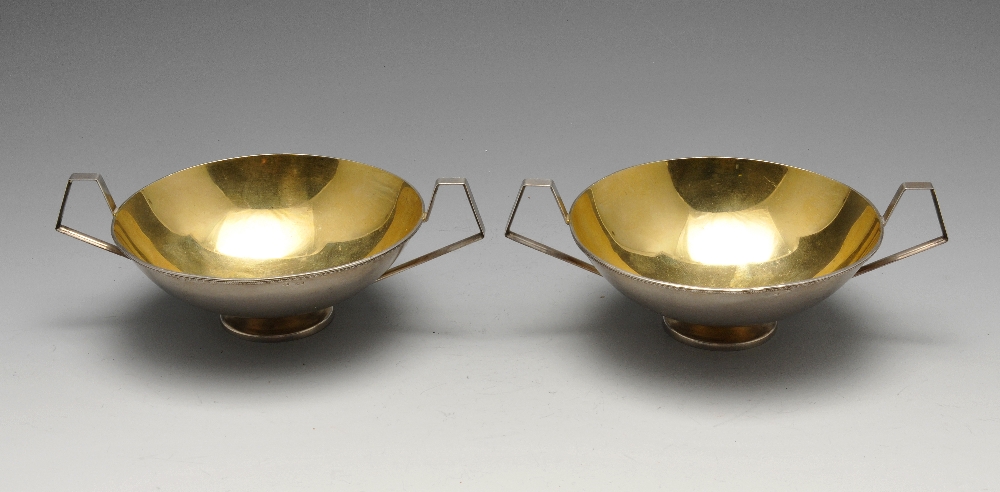 A pair of modern Russian dishes, the shallow circular forms with angular handles and silver-gilt