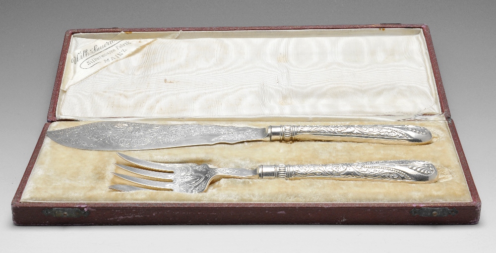 A cased pair of Victorian silver fish servers with ornate foliate scroll decoration, hallmarked John