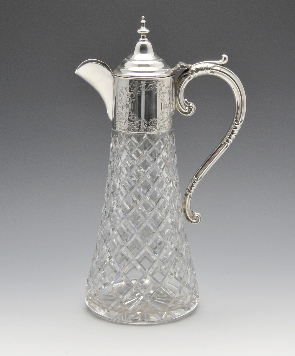 A modern silver mounted claret jug, the tapering glass body with a graduated diamond cut pattern