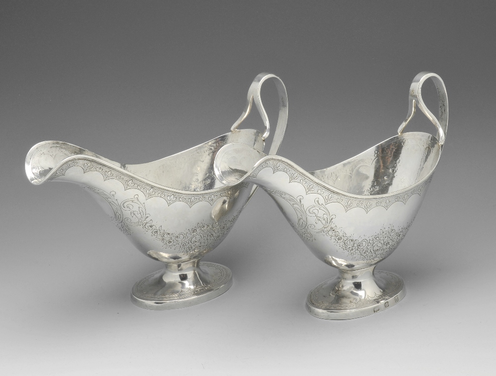 A pair of Indian Colonial? sauce boats, each with beaded rim, floral engraved garland decoration,