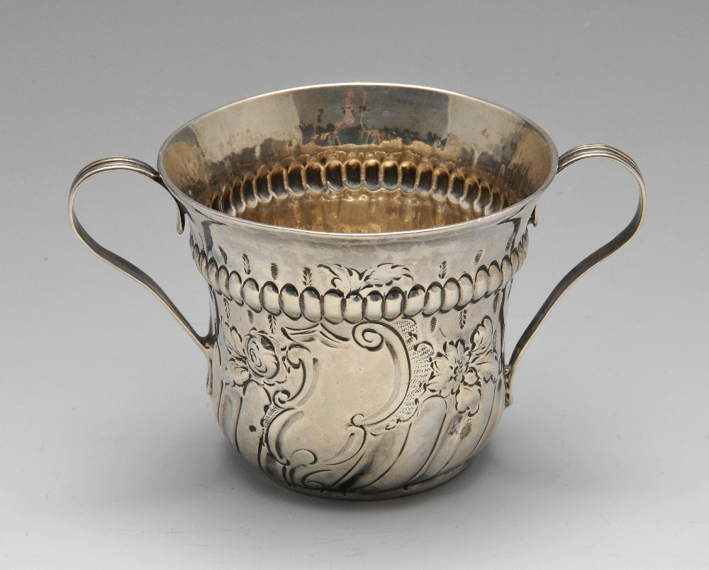 A George III silver porringer, the typical form with oblique fluted body rising to the vacant