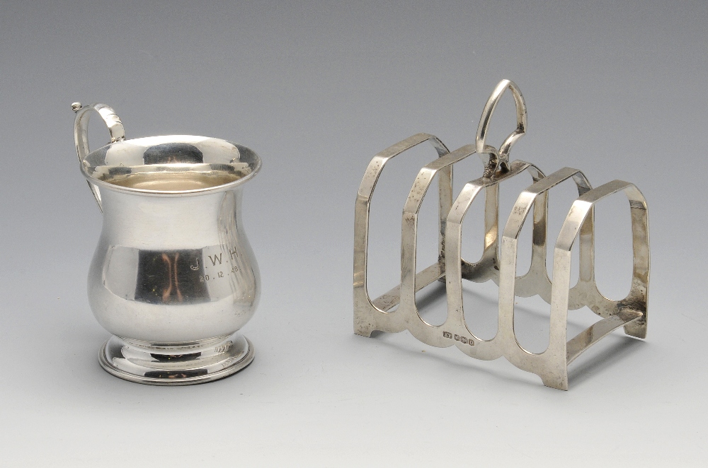 A 1940's silver christening mug, the baluster form with personal inscription and scrolling handle,