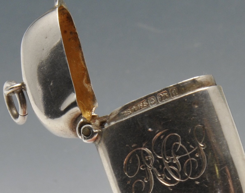 An Edwardian silver vesta case of plain oblong form with engraved family crest to the front, - Image 5 of 7