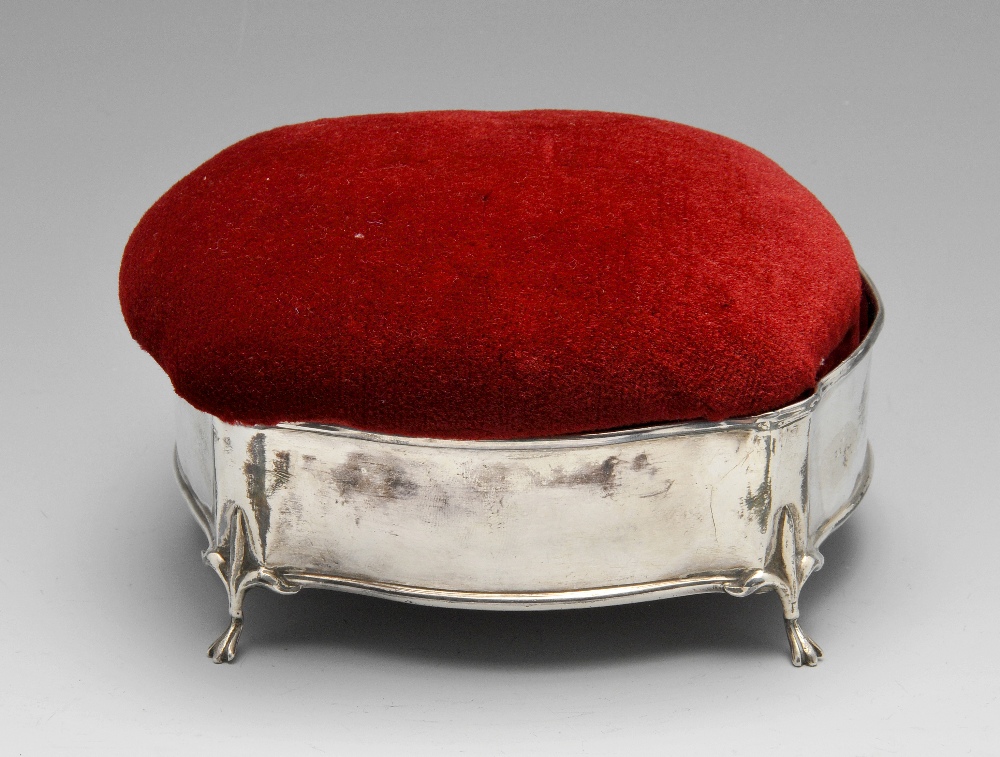 An early twentieth century silver mounted jewellery box of oval scalloped form with red velvet